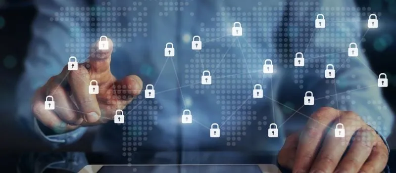 Hand pointing at a network of connected padlock icons representing layered data security