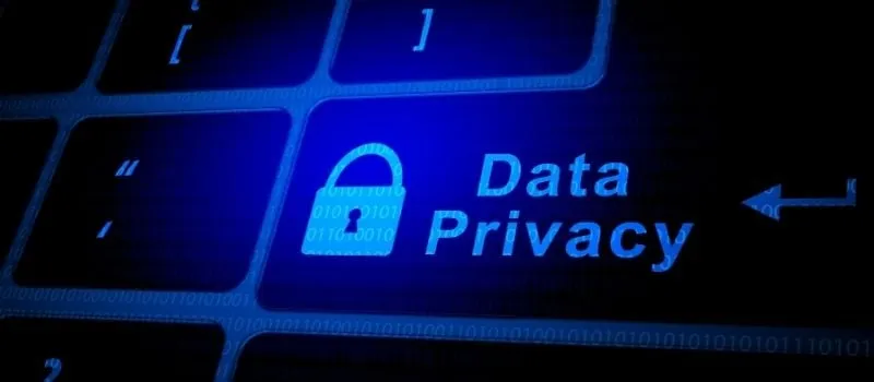 Glowing blue keyboard key labelled Data Privacy with a padlock icon