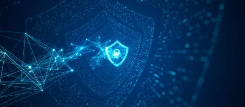 Glowing digital shield with a padlock and connected network lines representing cybersecurity